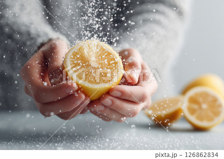 Hands Squeezing Juicy Lemons with Water Splashes 126862834