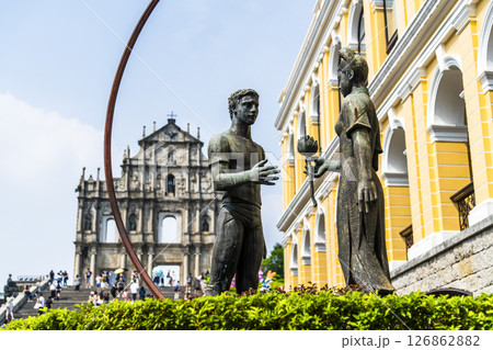 A sculpture of a young man and woman in front of the Ruins of St. Paul's at Jesus Company Square in Macau symbolizes the friendship between China and Portugal. 126862882