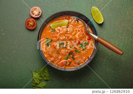 Brazilian traditional dish moqueca de camarao with shrimps, tomatoes, peppers, and lime in a bowl top view Brazilian traditional dish moqueca de camarao with shrimps, tomatoes, peppers, and lime in a bowl top view 126862910