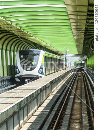 A Green Line train running on the elevated track of the Taichung Rapid Transit System in Taiwan.  126863047
