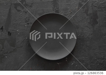Empty black slate plate on dark stone table. Food background for menu, recipe Empty black slate plate on dark stone table. Food background for menu, recipe 126863536
