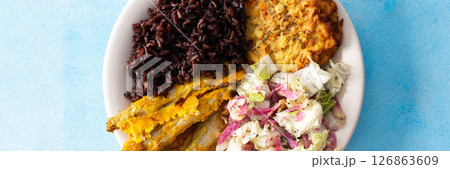 A wholesome and savory breakfast with brown rice and baked white fish, complemented by zucchini-carrot pancakes and a fresh Chinese cabbage salad with radish, banner 126863609