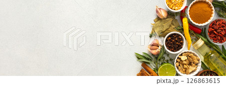 A wide selection of cooking spices and herbs on a gray background, perfect for adding depth to any dish, top view and copy space, banner A wide selection of cooking spices and herbs on a gray background, perfect for adding depth to any dish, top view and copy space, banner 126863615