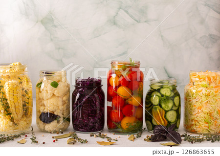 Fresh vegetables like cabbage, tomatoes, cucumbers, corn, peppers and cauliflower, fermenting naturally to boost health and preserve nutrients 126863655