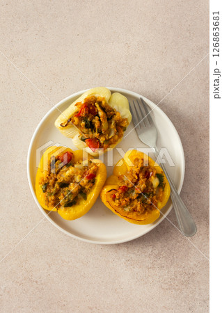 This nutritious dish of stuffed bell peppers with quinoa, lentils, and vegetables makes for a hearty, plant-based meal thats both flavorful and satisfying, perfect for any time of day 126863681