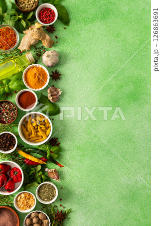 Fresh, fragrant spices and herbs arranged in an array of colors, sitting on a soft green backdrop, bringing flavor and zest to any kitchen, top view and copy space Fresh, fragrant spices and herbs arranged in an array of colors, sitting on a soft green backdrop, bringing flavor and zest to any kitchen, top view and copy space 126863691