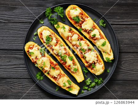 stuffed zucchini boats filled with bolognese sauce stuffed zucchini boats filled with bolognese sauce 126863944