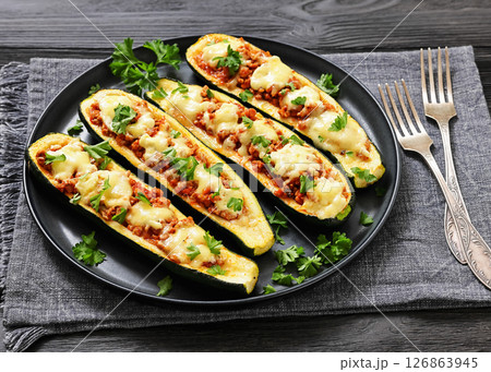 stuffed zucchini boats filled with bolognese sauce 126863945