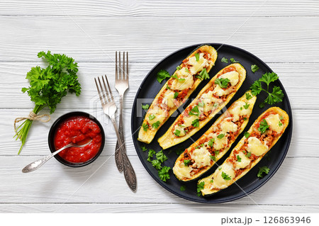 stuffed zucchini boats filled with bolognese sauce stuffed zucchini boats filled with bolognese sauce 126863946