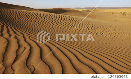 Sand blowing over sand dunes in wind Sand blowing over sand dunes in wind 126863968