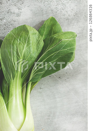 Fresh bok choy, close-up, on a light gray surface, top view, natural light, 126864316