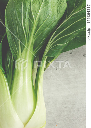 Fresh bok choy, close-up, on a light gray surface, top view, natural light, 126864317