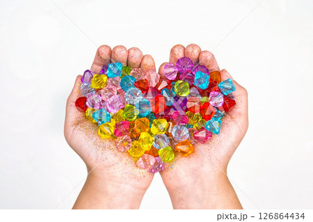 children's hands, hands holding beads on a white background children's hands, hands holding beads on a white background 126864434