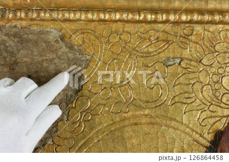 Restoration: gold restoration, old icon. close up. conservation of paintings. conservation of sculptures 126864458