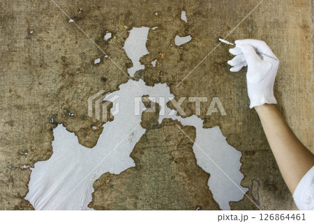 restoration and conservation of a very old canvas, restoration of a painting, restorer at work, place for text restoration and conservation of a very old canvas, restoration of a painting, restorer at work, place for text 126864461