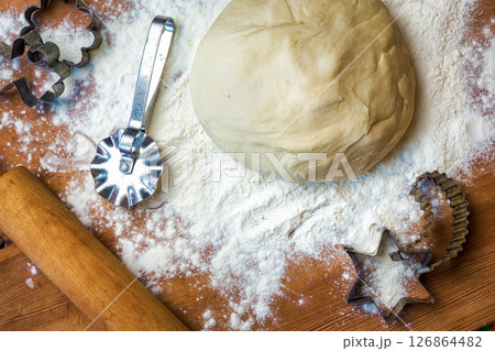 forms for squeezing the dough. dough on the table with dough tools. 126864482