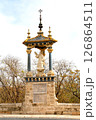 A Historic Monument Featuring a Statue in a Stone Pavilion Surrounded by Trees During Daylight 126864511