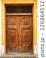 Intricately Designed Wooden Double Door in a Historic Building in a Picturesque Neighborhood 126864512