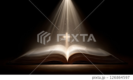 Open bible with cross radiating divine light inspiring christian faith and devotion 126864597