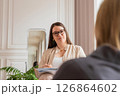 a female psychologist listens attentively to a female client in office. session with a psychologist. 126864602