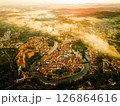 Stunning aerial view of Cesky Krumlov at dawn with mist rising over the river and picturesque rooftops 126864616