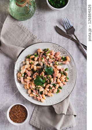 Protein tuna, beans, herb salad on a plate on the table top and vertical view 126864826