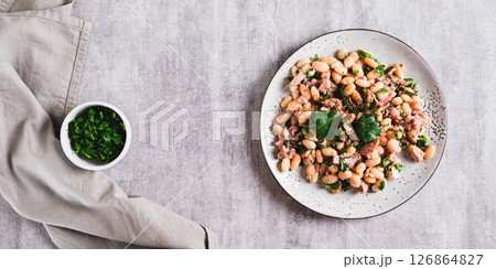 Protein tuna, beans, herb salad on a plate on the table top view web banner Protein tuna, beans, herb salad on a plate on the table top view web banner 126864827