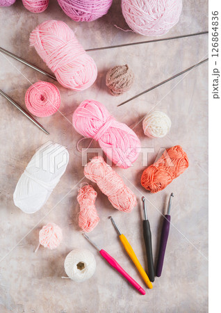 Yarn and tools for a cozy home knitting hobby on the table top and vertical view 126864836