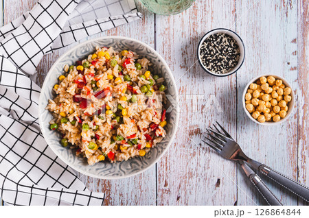 Homemade fried rice with peas, corn and pepper in a bowl on the table top view 126864844