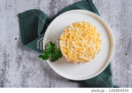 Close up of traditional layered salad with canned fish on a plate on the table top view 126864854