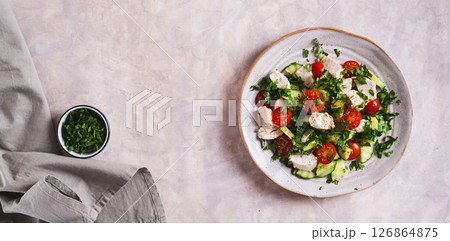 Fresh diet salad with chicken breast and vegetables on a plate on the table top view web banner Fresh diet salad with chicken breast and vegetables on a plate on the table top view web banner 126864875