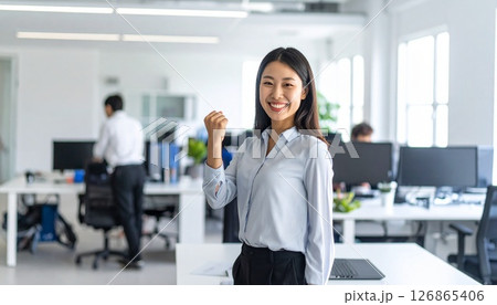 笑顔でガッツポーズする女性社員 126865406
