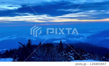 A Serene Winter Landscape At Dusk Showcasing Stunning SnowCapped Mountains In The Distance 126865647