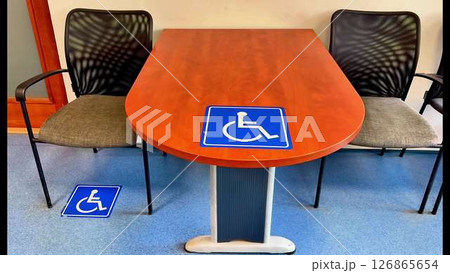 An Inclusive Meeting Space Featuring Wheelchair Symbols for Enhanced Accessibility and Comfort 126865654