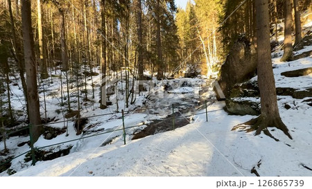 A Serene Winter Forest Landscape, beautifully featuring Snow and Rocks in harmony together A Serene Winter Forest Landscape, beautifully featuring Snow and Rocks in harmony together 126865739
