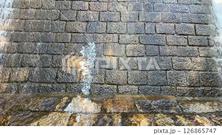 Stone Wall with Water Flowing Natures Beautiful Erosion Showcases Power of Time and Elements 126865747