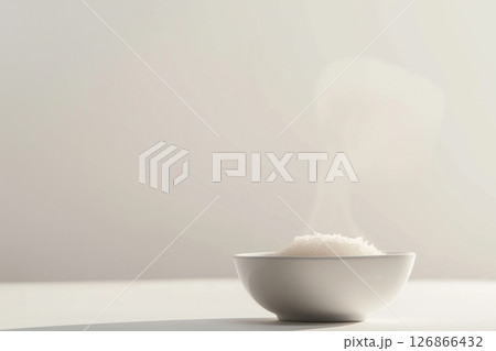 Steam rising from a bowl of hot white rice in a minimalist kitchen setting Steam rising from a bowl of hot white rice in a minimalist kitchen setting 126866432