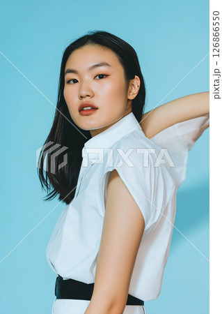 Portrait of a woman in elegant fashion style, showcasing beauty and chic clothing in an asymmetrical pose 126866550
