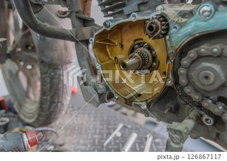 Mechanic checking gearbox in a workshop 126867117