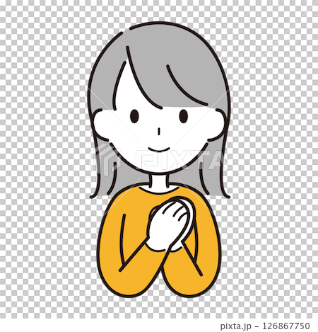 A woman smiling and praying with her hands together A woman smiling and praying with her hands together 126867750