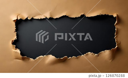 Detailed view of torn paper against a black backdrop, emphasizing the sharp edges and unique texture of the material 126870288