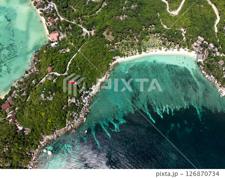 Tropical bay featuring clear turquoise waters, vibrant coral reefs, and lush greenery along the coastline. Thailand, Koh Tao. 126870734