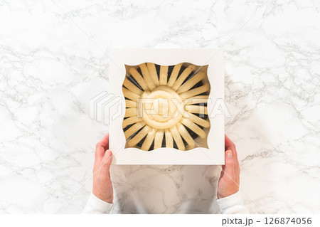 Flat lay. With care, the Chocolate Bundt Cake is packaged into a white paper box - ready for gifting to bring joy and indulgence to someone special. 126874056