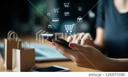 スマートフォンでネットショッピングを楽しむ女性と買い物袋のイラスト 126875380