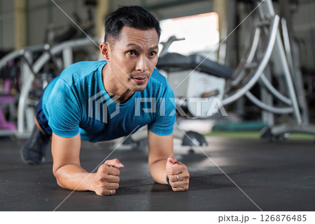 Fitness Core Strength. Man performing plank exercise in gym. 126876485