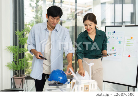 ESG Principles in Architecture. Young professionals collaborating on design model. 126876500
