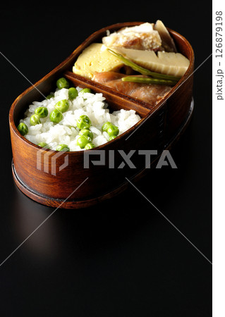 おかずたっぷり豆ご飯弁当を黒背景で撮影 126879198