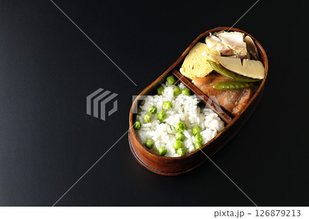 おかずたっぷり豆ご飯弁当を黒背景で撮影 おかずたっぷり豆ご飯弁当を黒背景で撮影 126879213