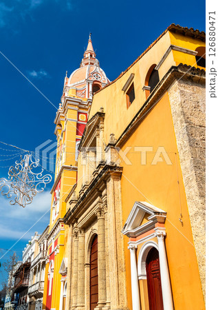 Close-up view of the Cathedral of Saint Catherine of Alexandria in Cartagena, Colombia, showcasing its colorful dome and stone facade under a vivid blue sky Close-up view of the Cathedral of Saint Catherine of Alexandria in Cartagena, Colombia, showcasing its colorful dome and stone facade under a vivid blue sky 126880471