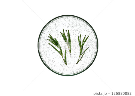 The texture of rosemary serum in a petri dish on a white isolated background. The texture of rosemary serum in a petri dish on a white isolated background. 126880882